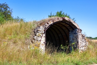 Underground passage or shelter in the middle of a field.